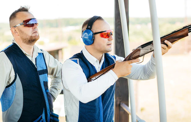 two adult mans sunglasses rifle vest practicing fire weapon shooting 281858 3115 eduexpert leszno